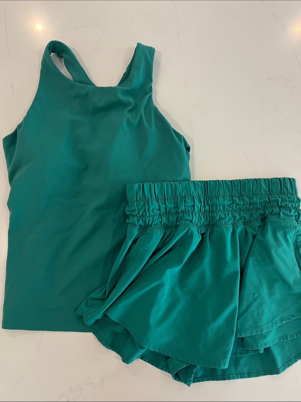 Women’s Crz Yoga matching Tank and Skirted Short Overlay. Cascadia Green